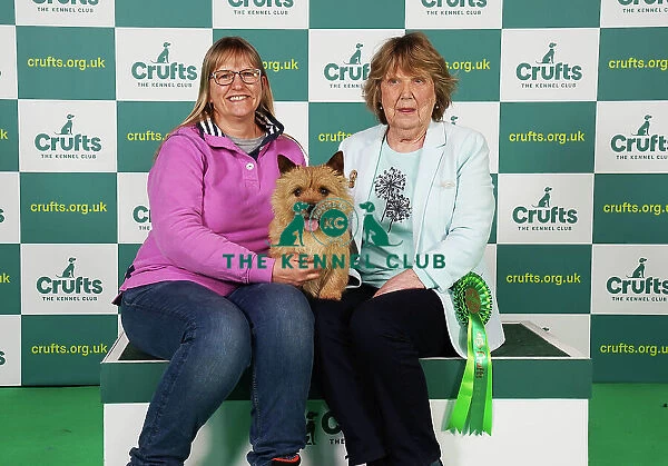 Frances Martin and Janet Lazenby from West Sussex with Bertie, a Norwich Terrier, which was the Best of Breed winner today (Saturday 11. 03. 23), the third day of Crufts 2023, at the NEC Birmingham