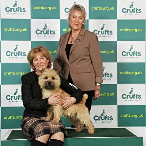 Elizabeth Theodorson and Merril Schmitt from Canada with Danny, a Cairn Terrier, which was the Best of Breed winner today (Saturday 11. 03. 23), the third day of Crufts 2023, at the NEC Birmingham
