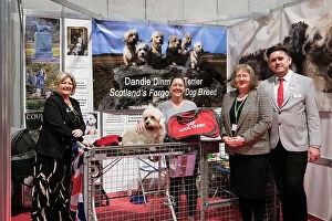 The Caledonian Dandie Dinmont Terrier Club being awarded the Best Discover Dogs Stand for the Terrier Group at Crufts on Sunday 10th March 2024 by Alison Scutcher, Nicky Ackerley-Kemp (Directors at The Kennel Club) and Ricky Furnell from Royal Canin