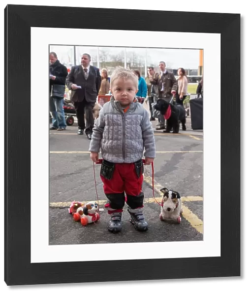 General shot on Friday of little boy arriving with two toy dogs