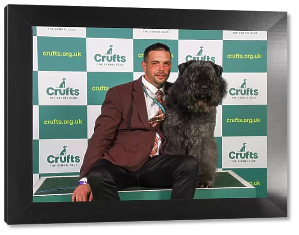 Attile Schlosser from Hungary with, a Bouvier des Flandres, which was the Best of Breed winner today (Friday 10. 03. 23), the second day of Crufts 2023, at the NEC Birmingham