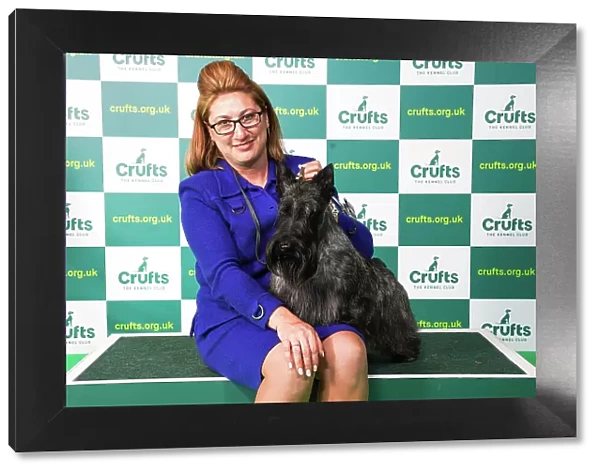 Rebecca Cross from Pennsylvania, USA, with Jasper, a Scottish Terrier, which was the Best of Breed winner today (Saturday 11. 03. 23), the third day of Crufts 2023, at the NEC Birmingham