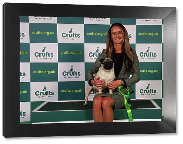 Holly Attwood from Dronfield with Dot, a Pug, which was the Best of Breed winner today (Sunday 12. 03. 23), the last day of Crufts 2023, at the NEC Birmingham