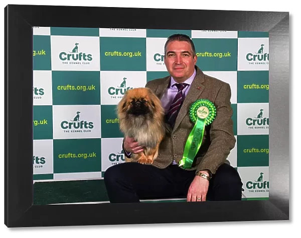 Lionel Prouve from Wales, with Simo, a Tibetan Spaniel, which was the Best of Breed winner today (Sunday 12. 03. 23), the last day of Crufts 2023, at the NEC Birmingham
