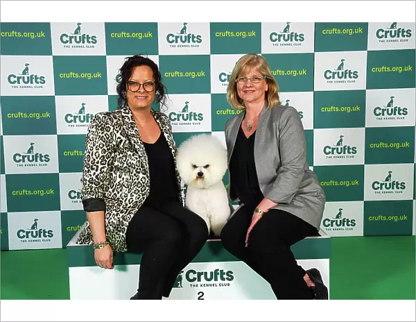 Sharon Walton and Tamara Wallbridge from Cornwall, with Moose a Bichon Frise, which was the Best of Breed winner today (Sunday 12. 03. 23), the last day of Crufts 2023, at the NEC Birmingham