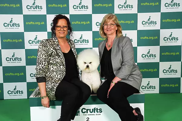 Sharon Walton and Tamara Wallbridge from Cornwall, with Moose a Bichon Frise, which was the Best of Breed winner today (Sunday 12. 03. 23), the last day of Crufts 2023, at the NEC Birmingham