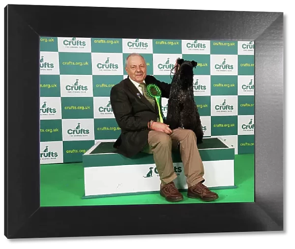 Paul Martin from Gloucestershire with Connie, a Kerry Blue Terrier, which was the Best of Breed winner today (Saturday 11. 03. 23), the third day of Crufts 2023, at the NEC Birmingham