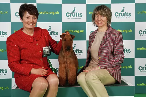 Joanne Vickers and Natalia Avveduti from Italy with Boris, an Irish Terrier, which was the Best of Breed winner today (Saturday 11. 03. 23), the third day of Crufts 2023, at the NEC Birmingham