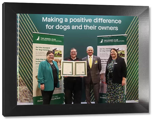 Lillie Abbot receiving her KCAI certificate for the Kennel Club Accredited Training Scheme with Paul Rawlings, Helen Kerfoot and Angela White, KCAI Vice Chair
