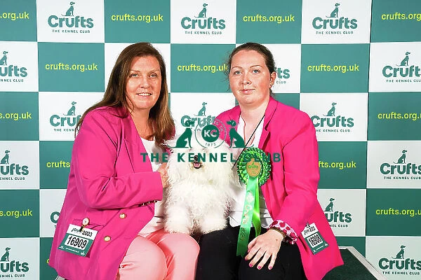 Carol Mulligan and Becky Mulligan from Isle of Wight, with Cassie, a Bolognese, which was the Best of Breed winner today (Sunday 12. 03. 23), the last day of Crufts 2023, at the NEC Birmingham
