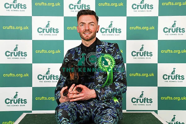 Craig Young from Henley, Ireland with Edward, a Dachshund (Smooth Haired), which was the Best of Breed winner today (Saturday 11. 03. 23), the third day of Crufts 2023, at the NEC Birmingham
