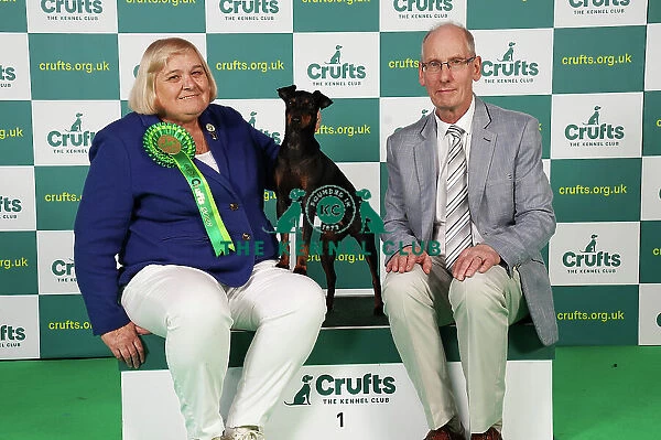 Gillian and Clive Knight from Barnsley with Tara, a Manchester Terrier, which was the Best of Breed winner today (Saturday 11. 03. 23), the third day of Crufts 2023, at the NEC Birmingham