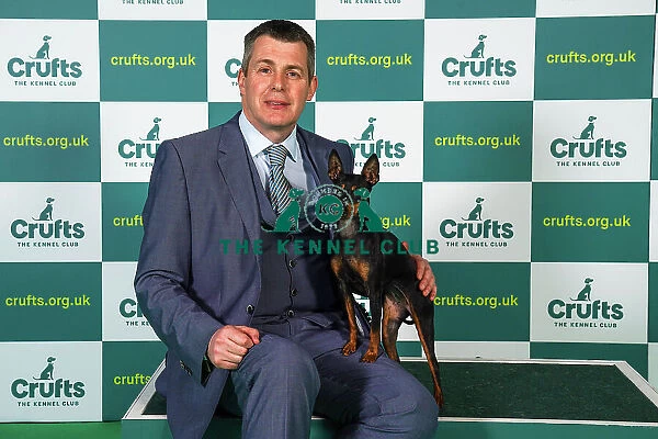 Graeme Dixon from Newcastle, with Tina, a English Toy Terrier (Black & Tan), which was the Best of Breed winner today (Sunday 12. 03. 23), the last day of Crufts 2023, at the NEC Birmingham