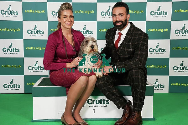 Janice Hayes and Eric Ciceron from California with Hemi, a Basset Griffon Vendeen (Petit), which was the Best of Breed winner today (Saturday 11. 03. 23), the third day of Crufts 2023, at the NEC Birmingham