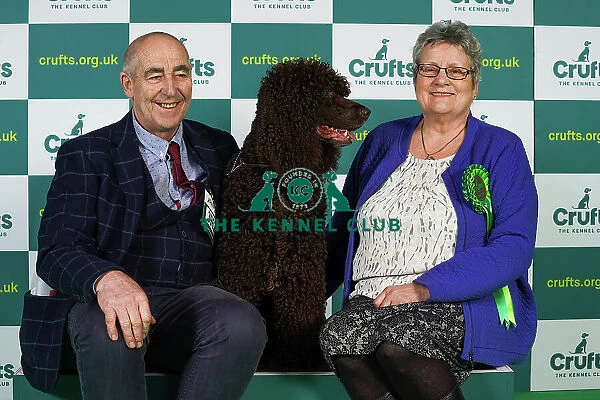 John Hackett and Angela Williams from Sunderland with Finn, an Irish Water Spaniel, which was the Best of Breed winner today (Thursday 09. 03. 23), the first day of Crufts 2023, at the NEC Birmingham