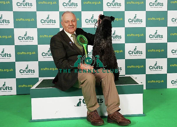 Paul Martin from Gloucestershire with Connie, a Kerry Blue Terrier, which was the Best of Breed winner today (Saturday 11. 03. 23), the third day of Crufts 2023, at the NEC Birmingham