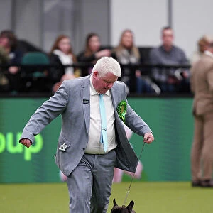Abbie Cund and Dean Cund from Birmingham, with Elton, a French Bulldog, which was the Best of Breed winner today (Sunday 12. 03. 23), the last day of Crufts 2023, at the NEC Birmingham