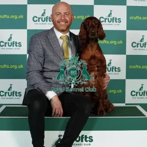 Blake Crocker from Somerset with Gloria, an Irish Setter, which was the Best of Breed winner today (Thursday 09. 03. 23), the first day of Crufts 2023, at the NEC Birmingham