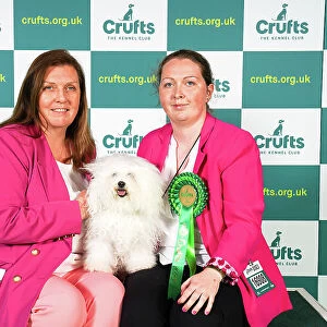 Carol Mulligan and Becky Mulligan from Isle of Wight, with Cassie, a Bolognese, which was the Best of Breed winner today (Sunday 12. 03. 23), the last day of Crufts 2023, at the NEC Birmingham