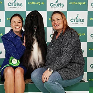 Claire Millward and Liz Millward from Sheffield with Alfie, an Afghan Hound, which was the Best of Breed winner today (Saturday 11. 03. 23), the third day of Crufts 2023, at the NEC Birmingham