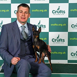 Graeme Dixon from Newcastle, with Tina, a English Toy Terrier (Black & Tan), which was the Best of Breed winner today (Sunday 12. 03. 23), the last day of Crufts 2023, at the NEC Birmingham