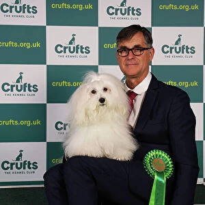 Kevin Holley from North Lincolnshire with Belle, a Coton de Tulear, which was the Best of Breed winner today (Sunday 12. 03. 23), the last day of Crufts 2023, at the NEC Birmingham