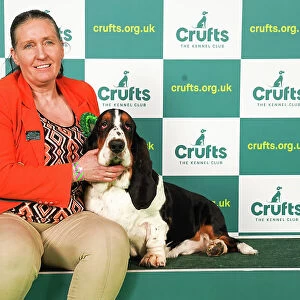 Liz Cudlip from County Durham with Bruce, a Basset Hound, which was the Best of Breed winner today (Saturday 11. 03. 23), the third day of Crufts 2023, at the NEC Birmingham