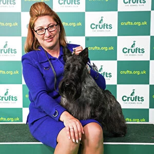 Rebecca Cross from Pennsylvania, USA, with Jasper, a Scottish Terrier, which was the Best of Breed winner today (Saturday 11. 03. 23), the third day of Crufts 2023, at the NEC Birmingham