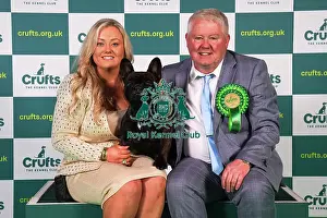 Abbie Cund and Dean Cund from Birmingham, with Elton, a French Bulldog, which was the Best of Breed winner today (Sunday 12. 03. 23), the last day of Crufts 2023, at the NEC Birmingham