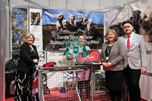 The Caledonian Dandie Dinmont Terrier Club being awarded the Best Discover Dogs Stand for the Terrier Group at Crufts on Sunday 10th March 2024 by Alison Scutcher, Nicky Ackerley-Kemp (Directors at The Kennel Club) and Ricky Furnell from Royal Canin