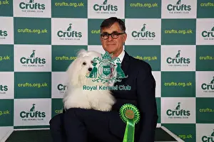 Kevin Holley from North Lincolnshire with Belle, a Coton de Tulear, which was the Best of Breed winner today (Sunday 12. 03. 23), the last day of Crufts 2023, at the NEC Birmingham