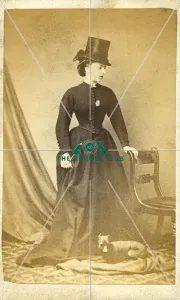 Manchester Terrier with woman wearing riding hat