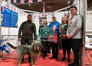 The Otterhound Club being awarded the Best Discover Dogs Stand for the Hound Group at Crufts on Sunday 10th March 2024 by Alison Scutcher, Nicky Ackerley-Kemp (Directors at The Kennel Club) and Ricky Furnell from Royal Canin