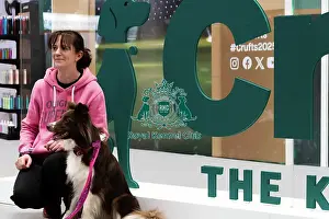 Border Collie Prints: Owners Posing With Their Border Collie In Front Of The Crufts Banner